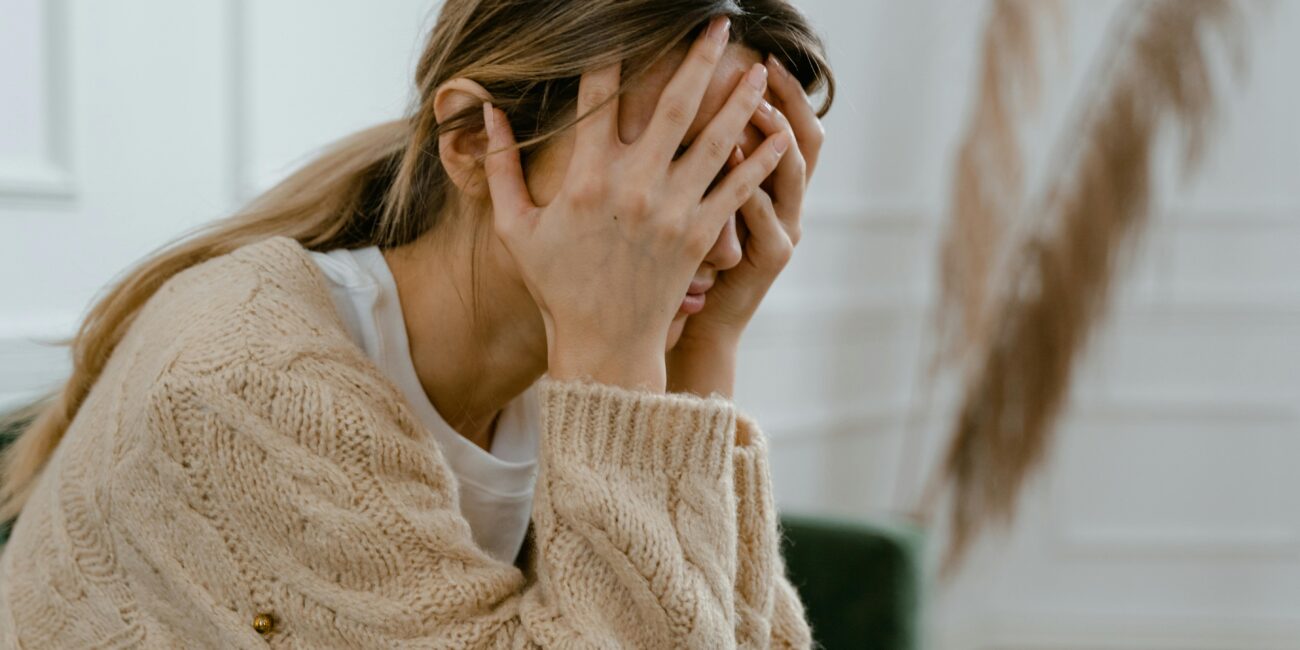 Women with hands on her face | OCD